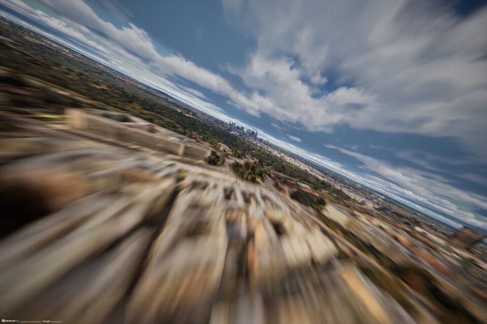 Fast FPV flight over a city with motion blur